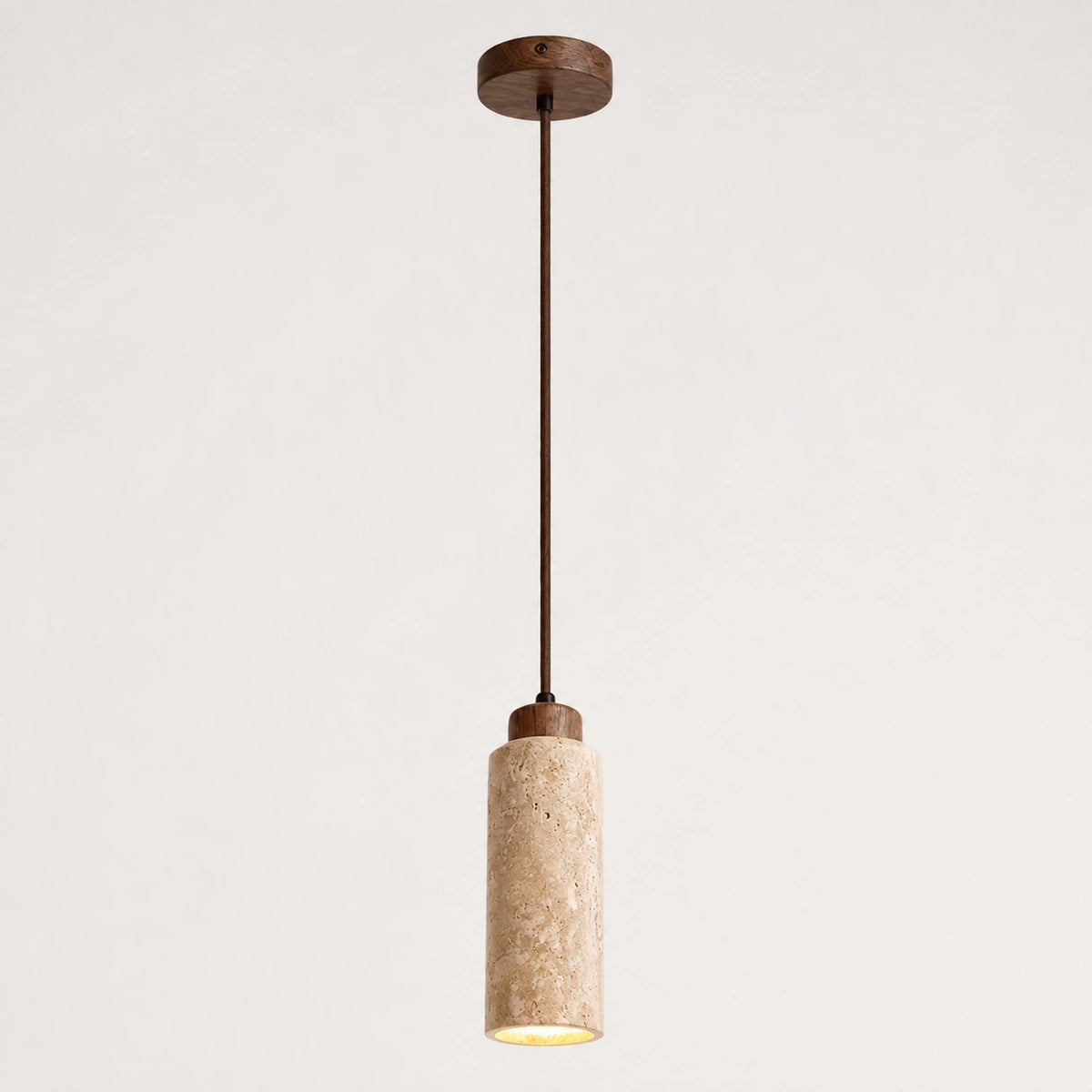 Slim honey travertine cylinder pendant light with a wooden cap on a white background