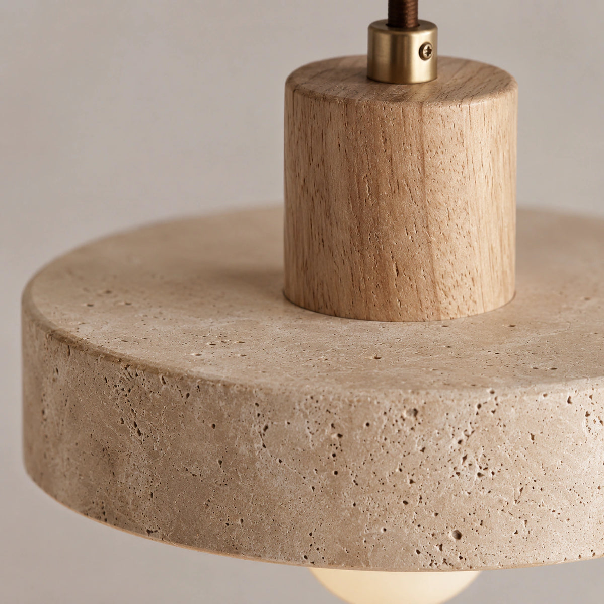 Close-up of the travertine banding on the rim of the Salcombe disc pendant in oak