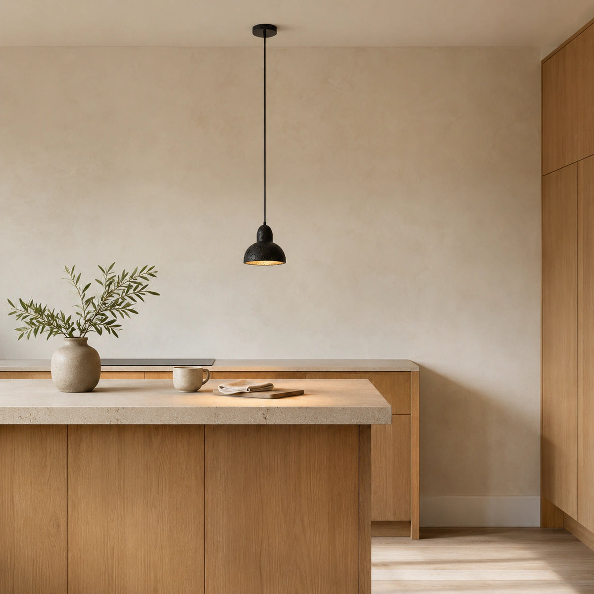 Blackmoor black travertine dome pendant hanging above a kitchen island