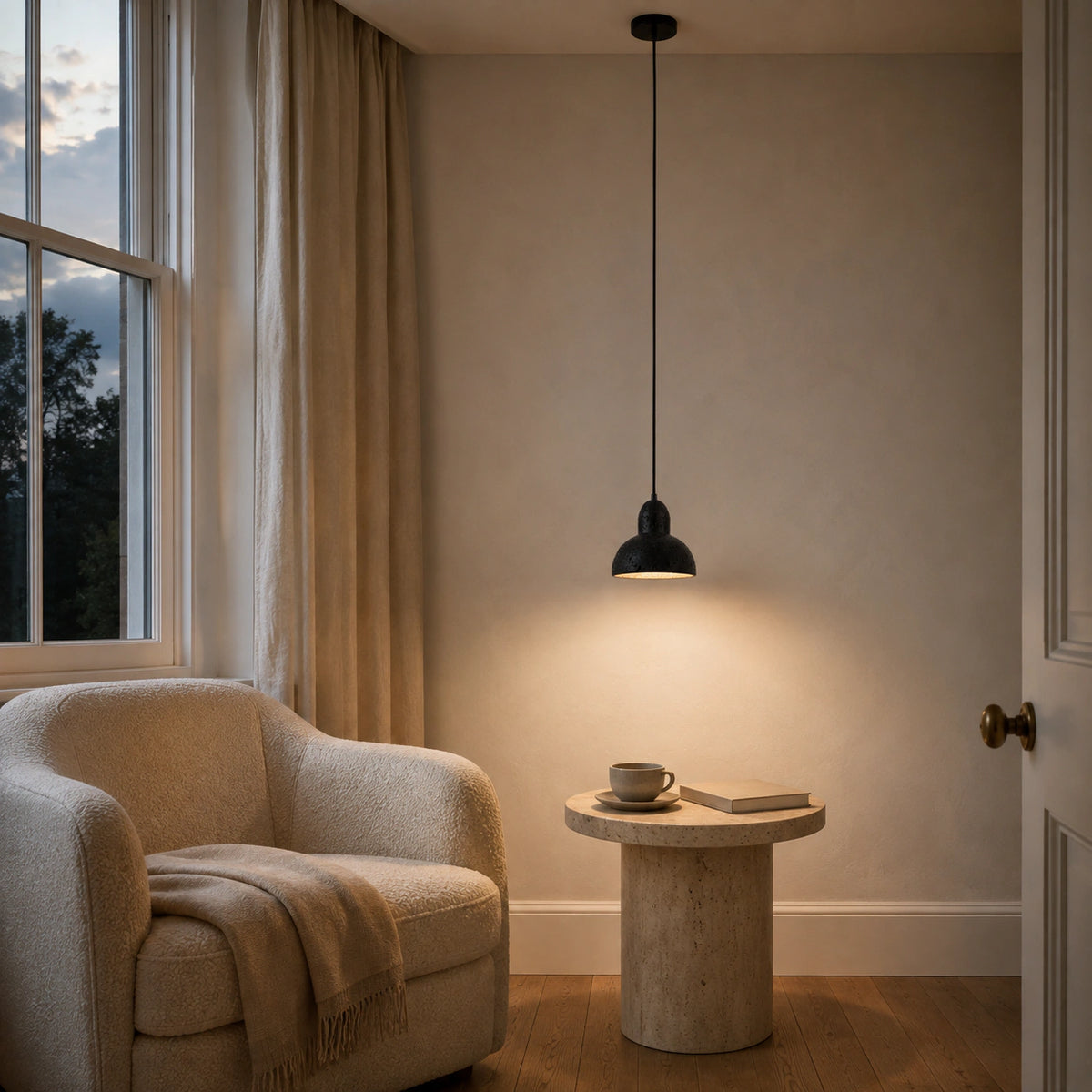 Blackmoor black travertine dome pendant in a calm living room with neutral furnishings