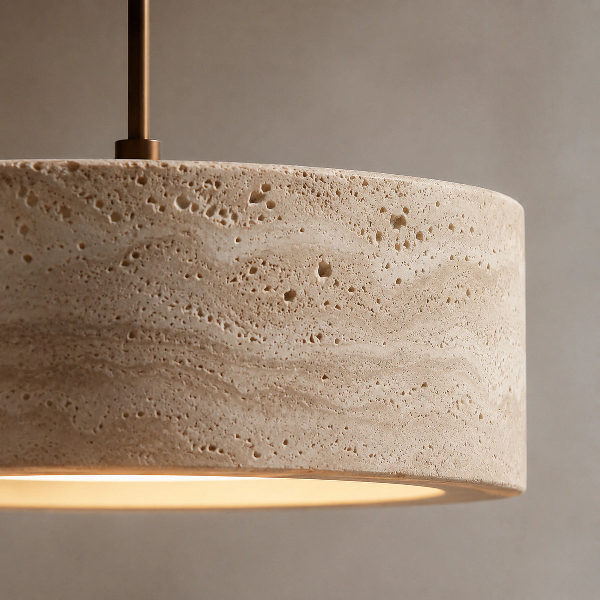 Close-up of the travertine grain on the wide drum pendant