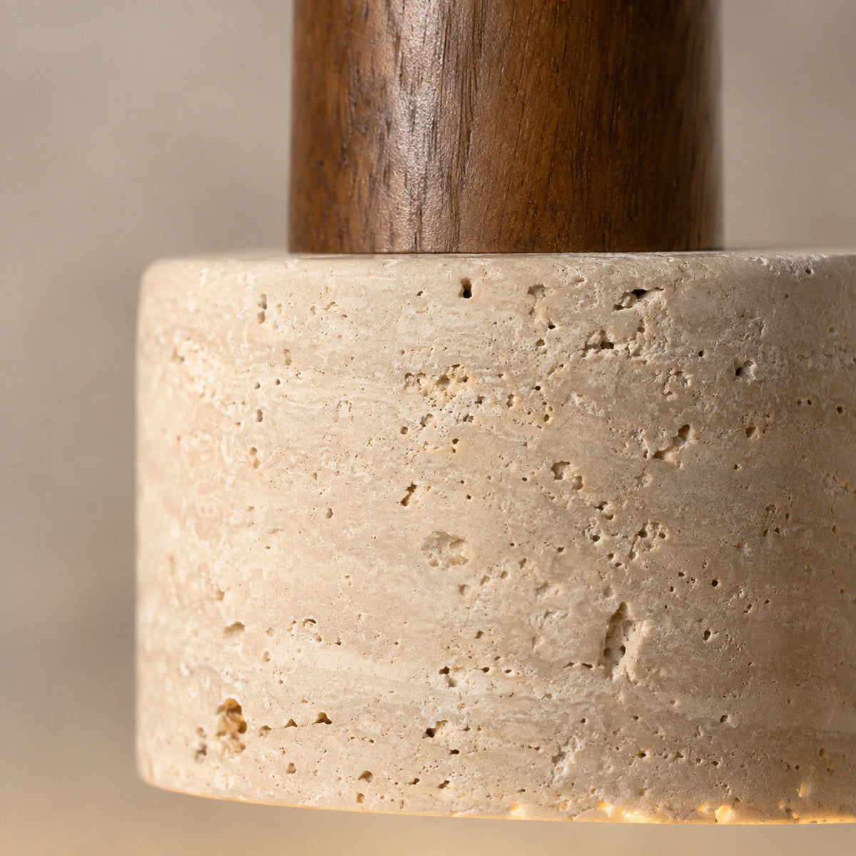 Close-up of the beige travertine grain and walnut neck on the Grantley pendant