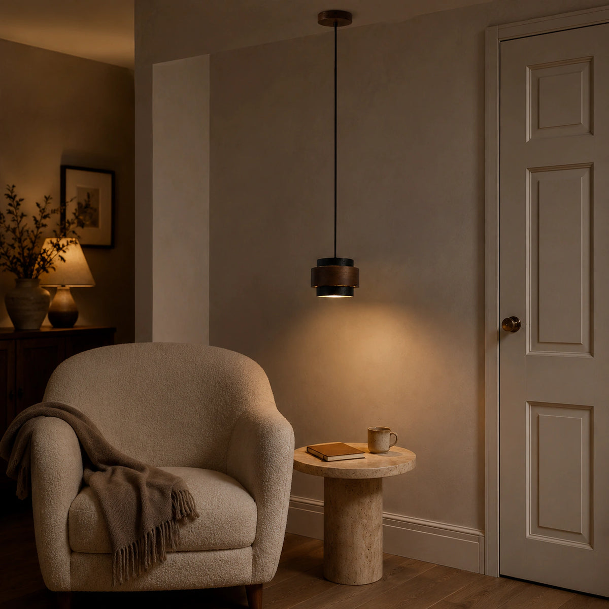 Barrow tiered pendant in black travertine in a calm living room with neutral furnishings