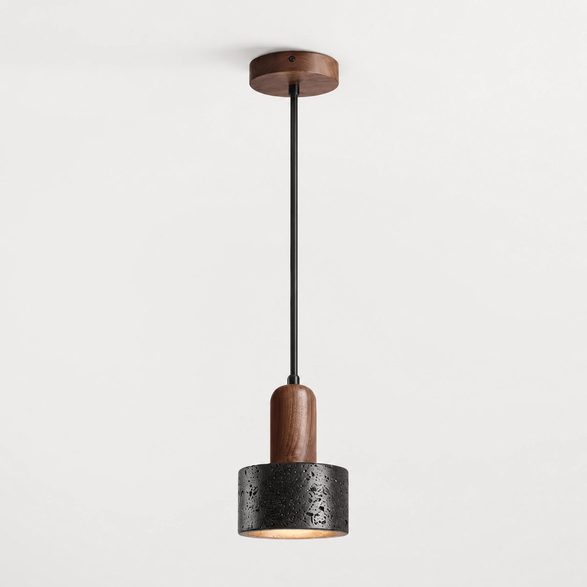 Black travertine drum pendant light with a walnut neck on a white background