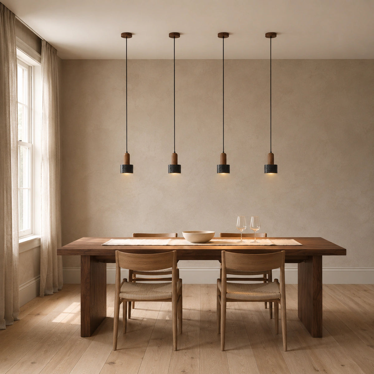 Grantley pendant in walnut and black travertine above a dining table