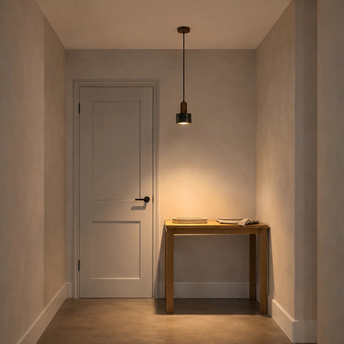 Grantley pendant in walnut and black travertine lighting a hallway in a period property