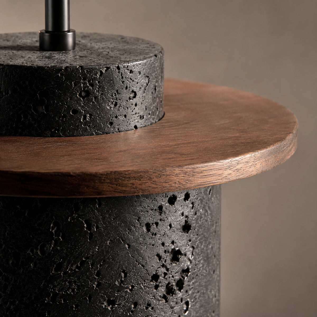 Close-up of the black travertine drum meeting the walnut brim on the Hatfield pendant