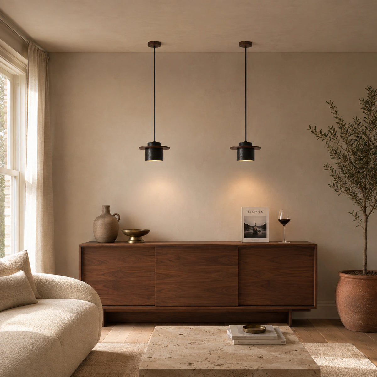 Hatfield pendant in black travertine in a calm living room with neutral furnishings