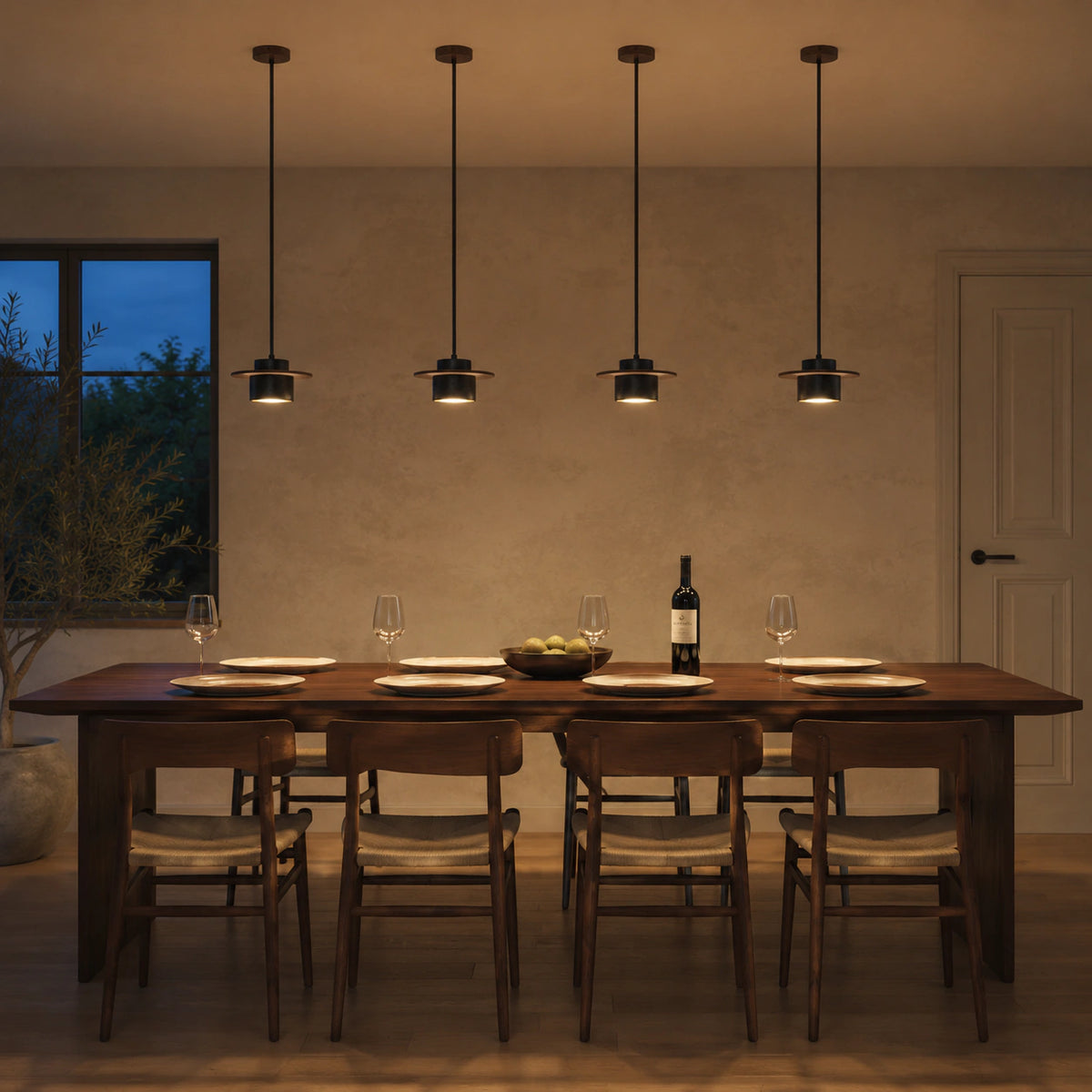 Hatfield pendant in black travertine above a dining table in a minimalist dining room