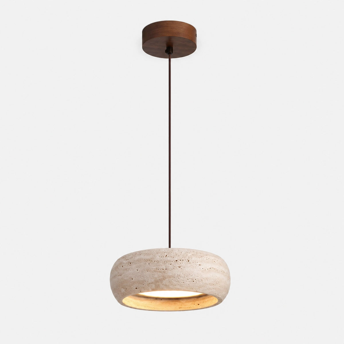 Rounded travertine pendant with a pillowed profile on a white background