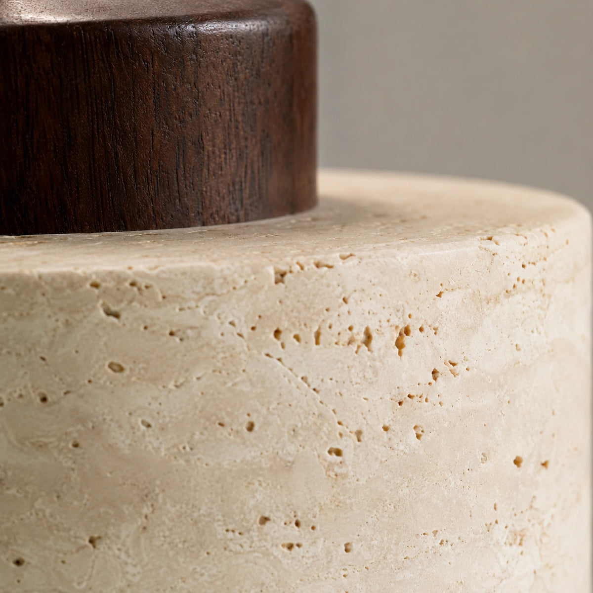 Close-up of the travertine grain and walnut collar on the Whitby drum pendant