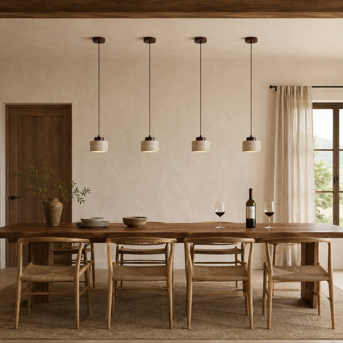 Whitby travertine drum pendant in walnut above a dining table in a minimalist dining room