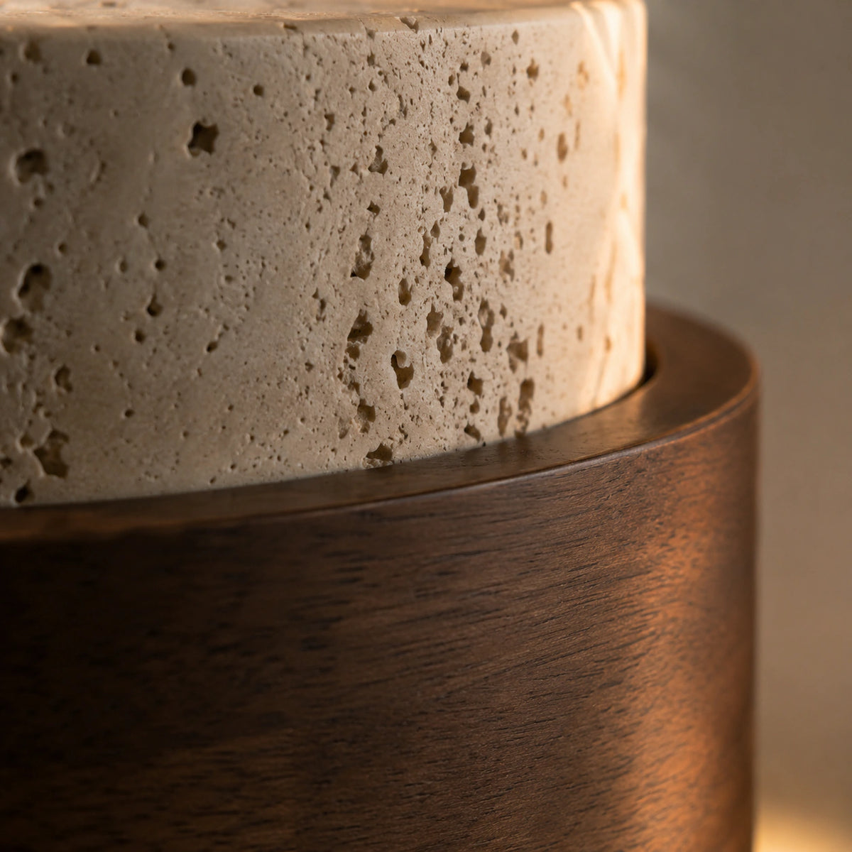 Close-up of the cream travertine and walnut band on the Barrow tiered pendant