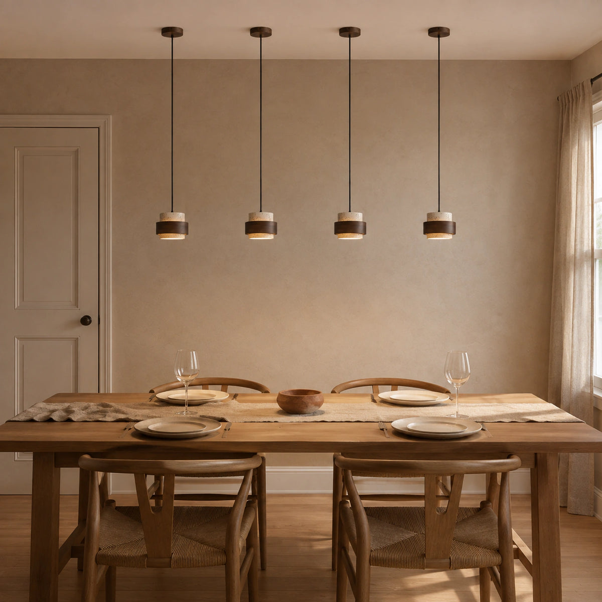 Barrow tiered pendant in cream travertine above a dining table in a minimalist dining room
