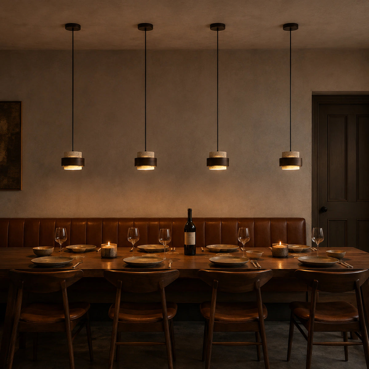 Barrow tiered pendant in cream travertine above a restaurant table with banquette seating