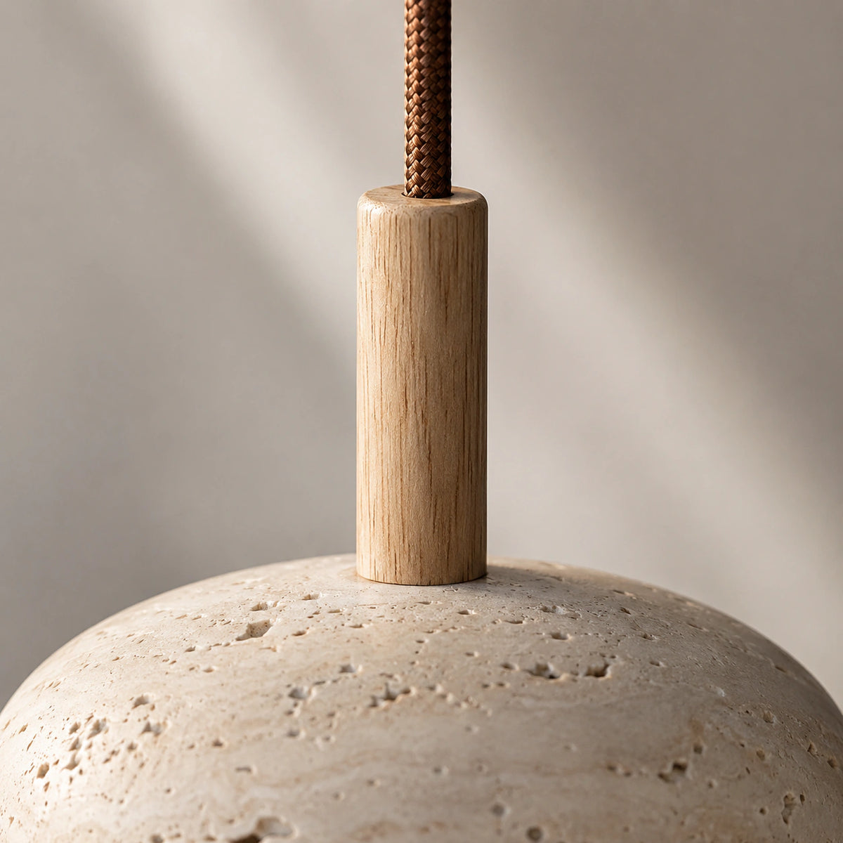 Close-up of the travertine grain and open pores on the Elmore disc pendant