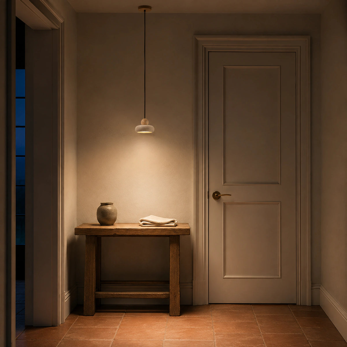 Travertine pebble pendant lighting a plastered hallway in a period home