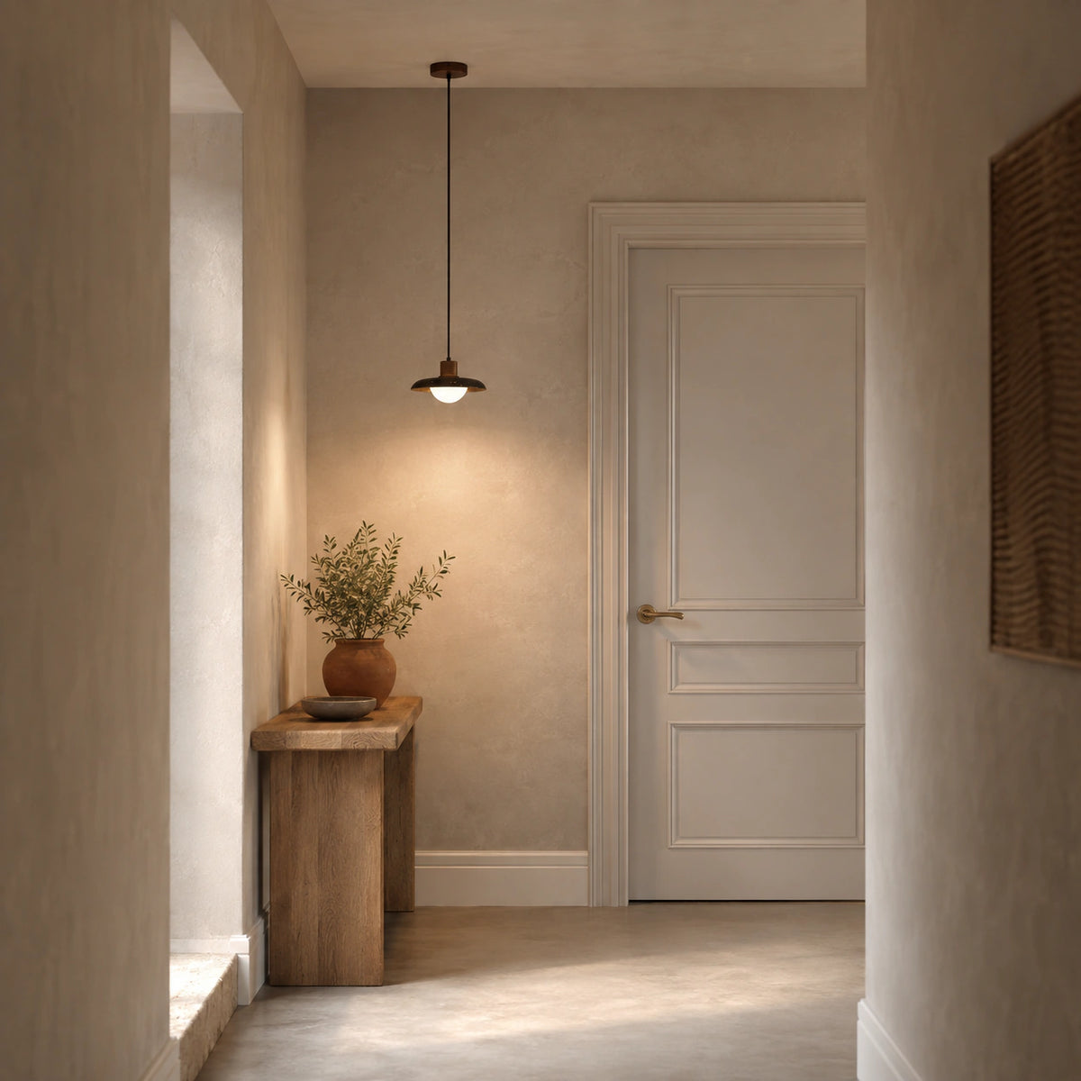 Halden black travertine saucer pendant lighting a hallway in a period property