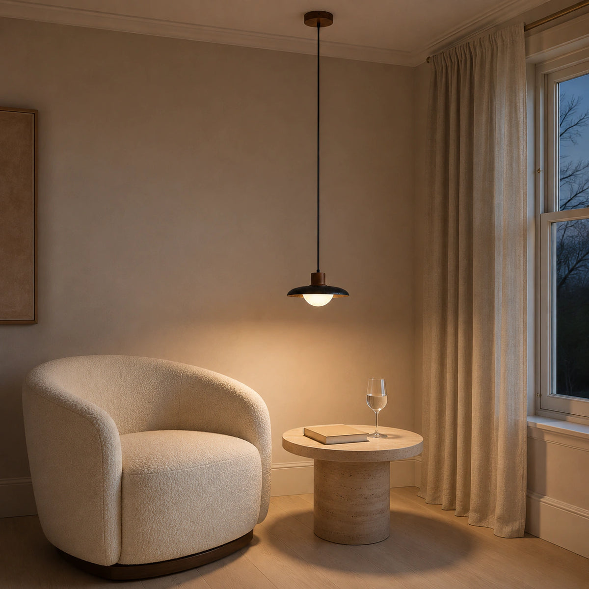 Halden black travertine saucer pendant in a calm living room with neutral furnishings