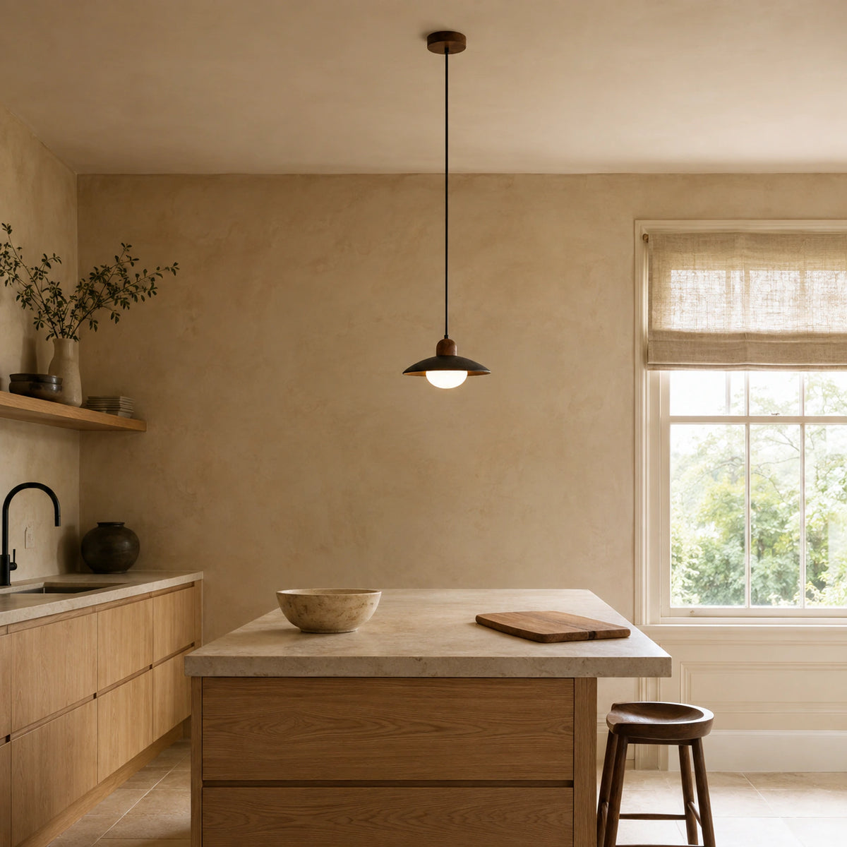 Marsden black travertine saucer pendant hanging above a kitchen island