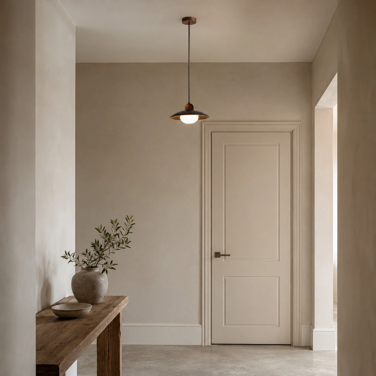Marsden black travertine saucer pendant lighting a hallway in a period property