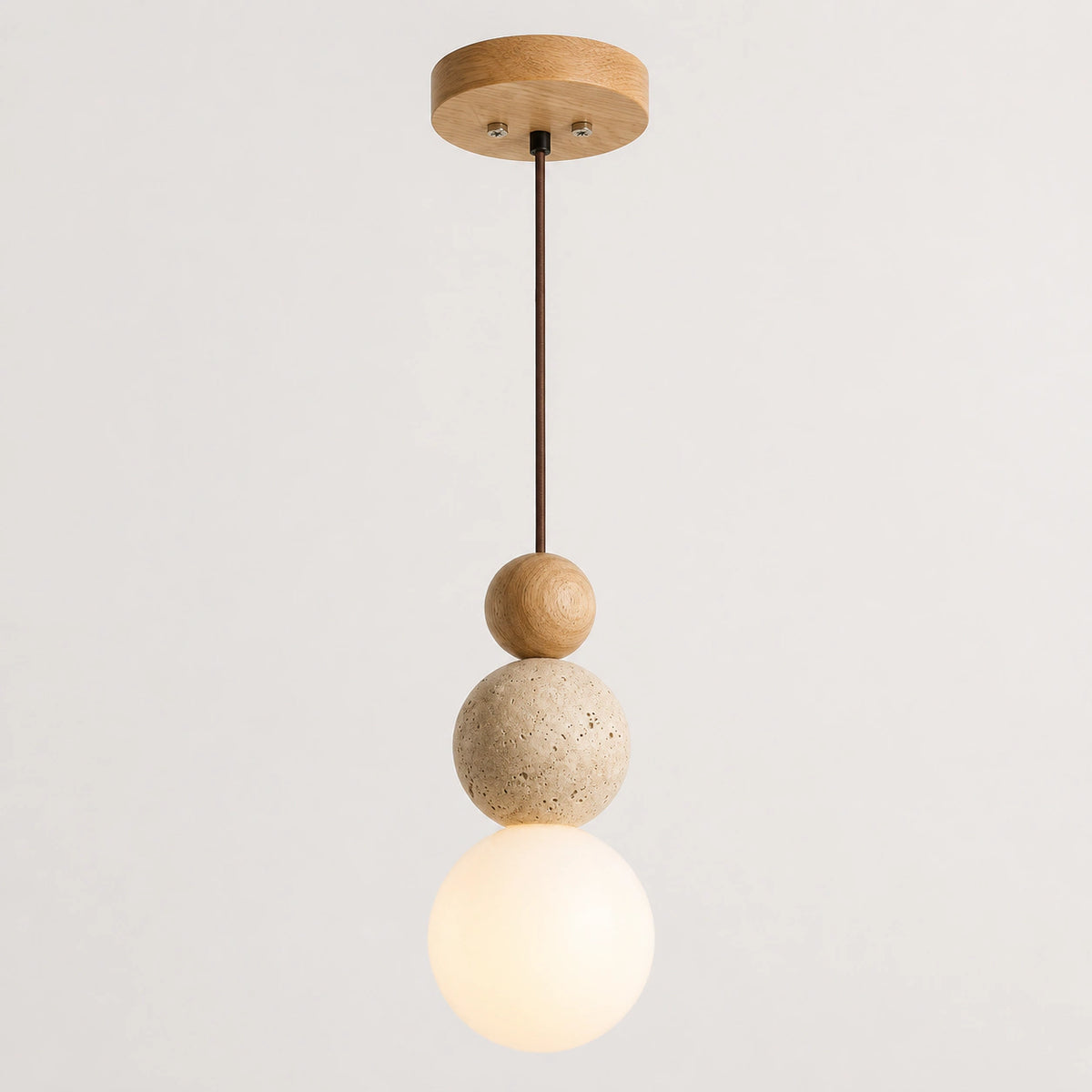 Travertine sphere pendant light with an oak ball and opal glass globe on a white background