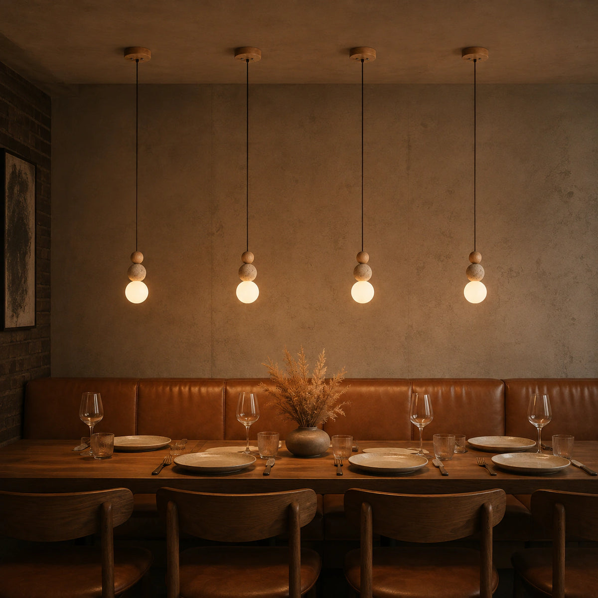 Sudbury travertine sphere pendant in oak above a restaurant table with banquette seating