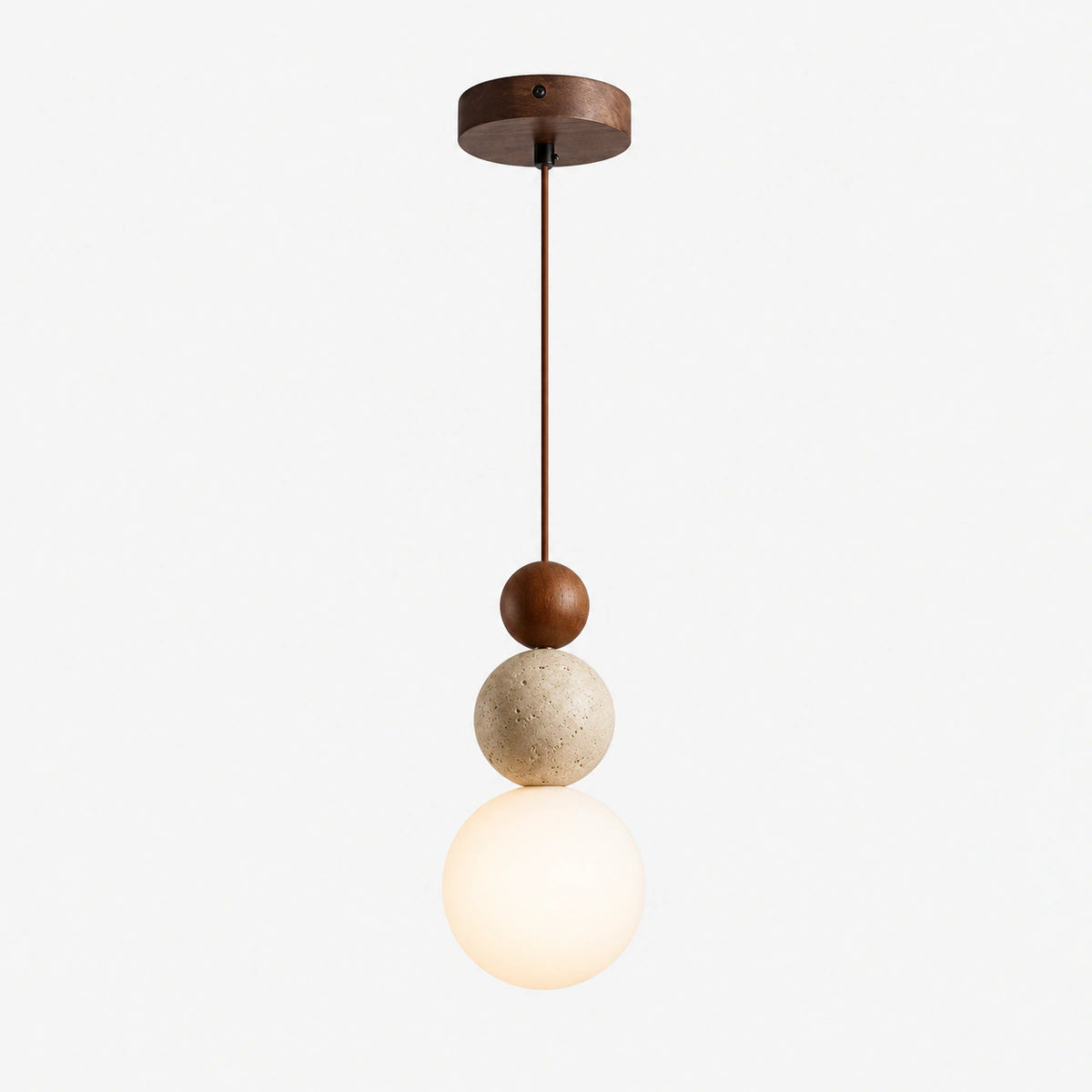 Travertine sphere pendant light with a walnut ball and opal glass globe on a white background