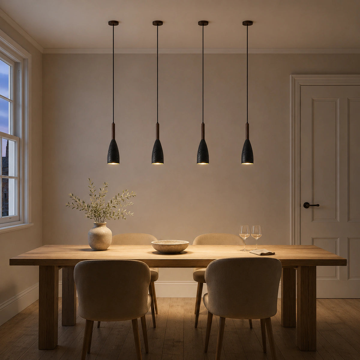 Coalbrook tall black travertine pendant above a dining table in a minimalist dining room