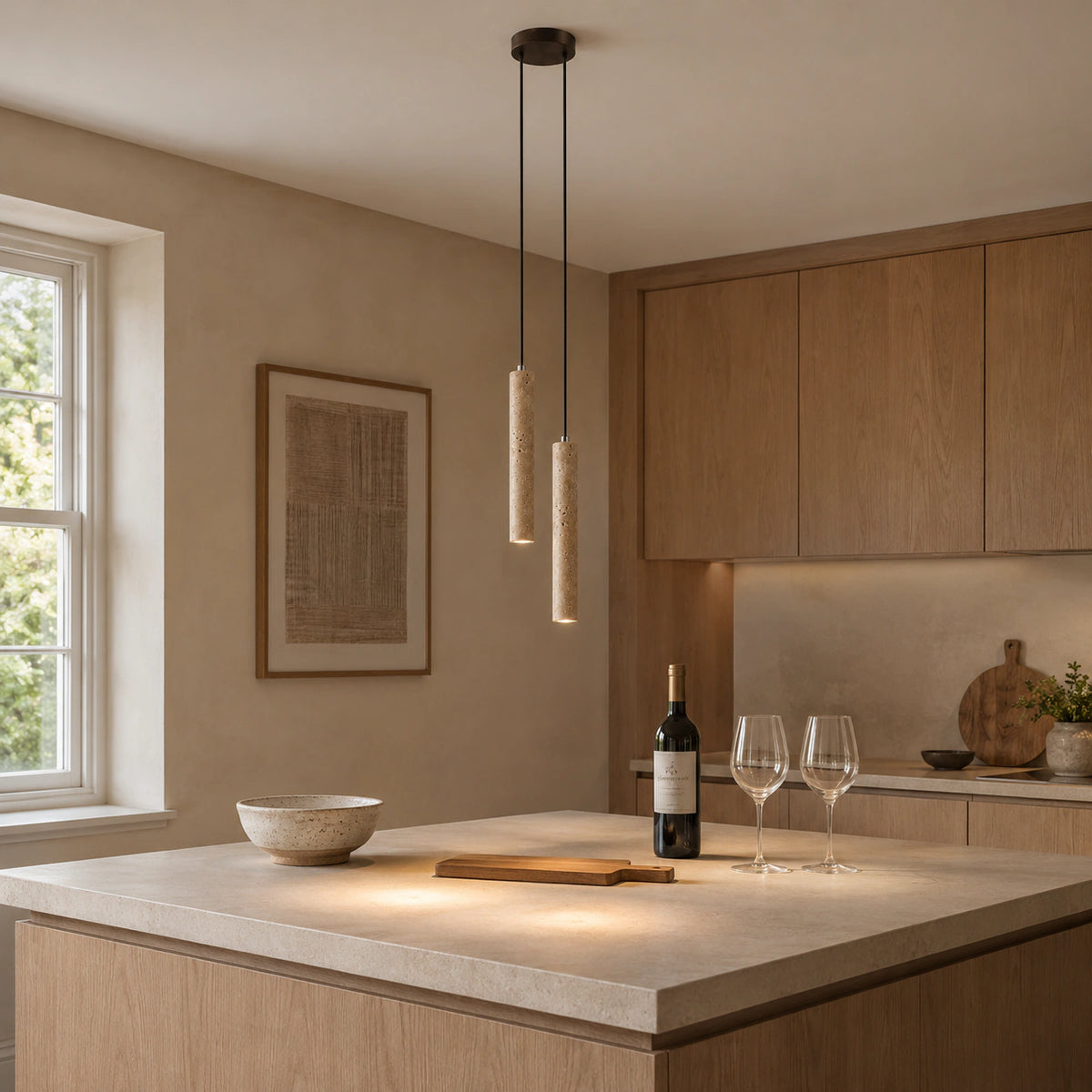 Chesil travertine tube cluster pendant lit above a kitchen worktop