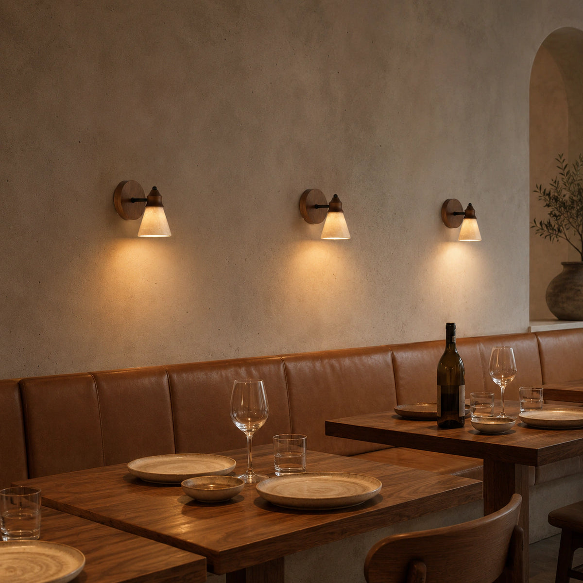 Ashwell travertine cone wall lights along a restaurant wall