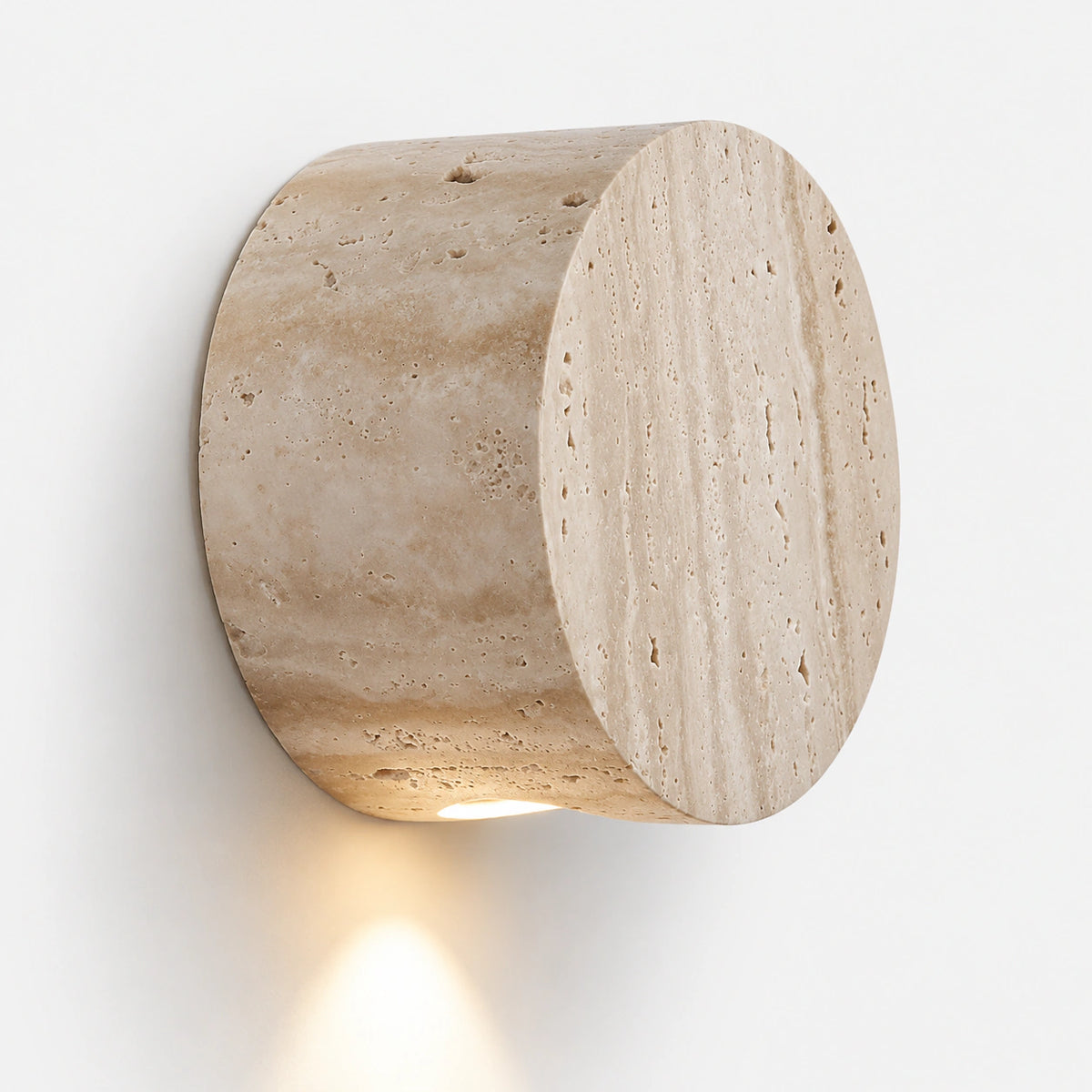 Cream travertine disc wall light with two offset discs on a white wall