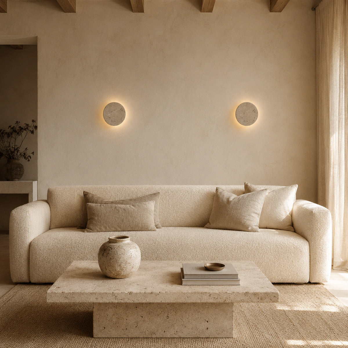 Windermere travertine halo wall light in a calm living room