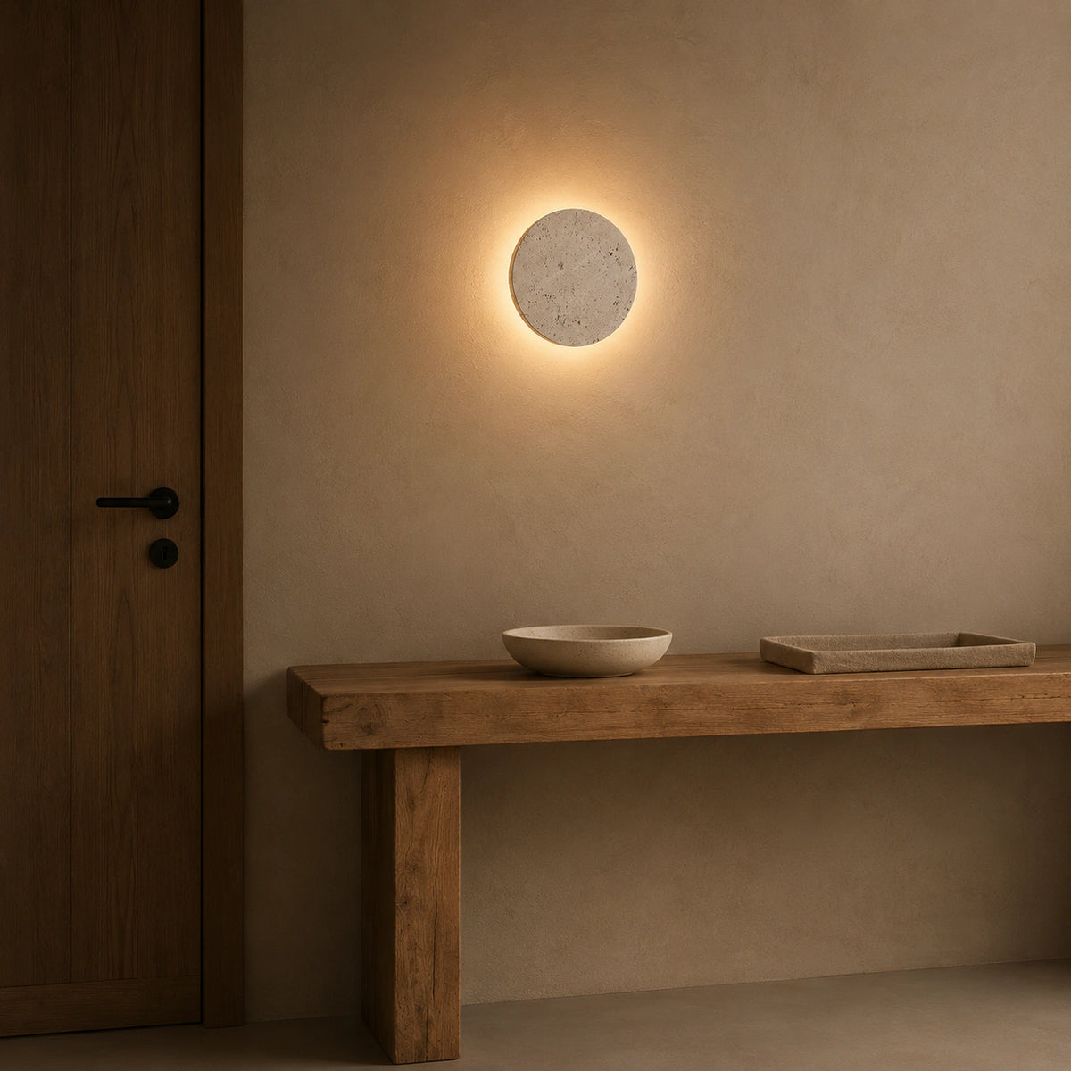Windermere travertine halo wall light lighting a hallway in a period property