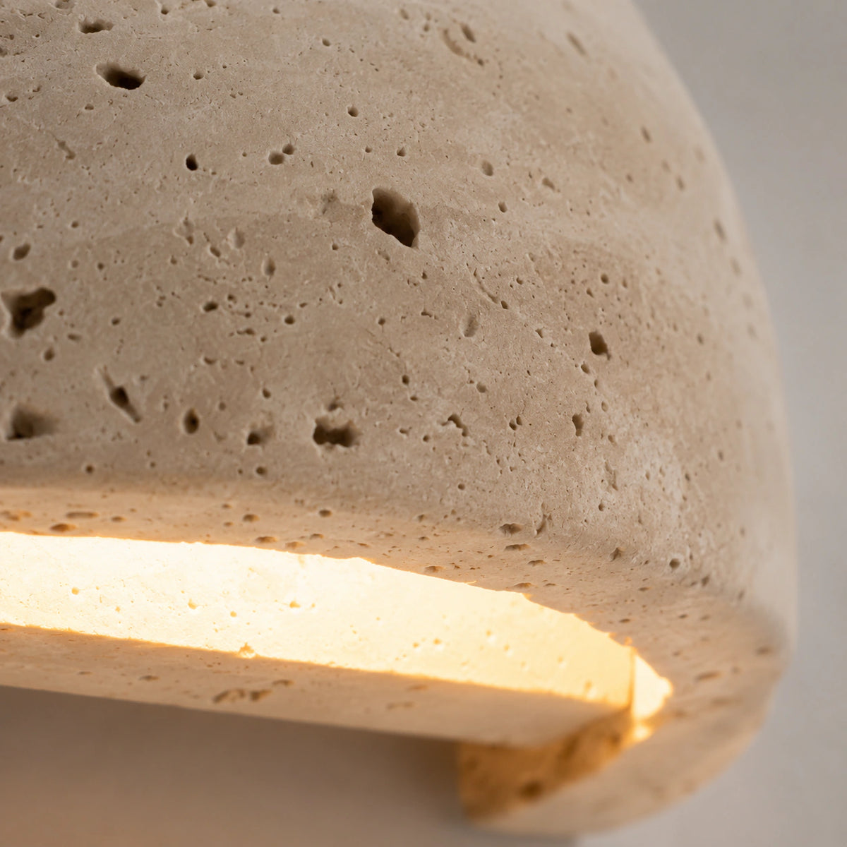 Close-up of the open pores along the curved rim of the Culver half dome wall light