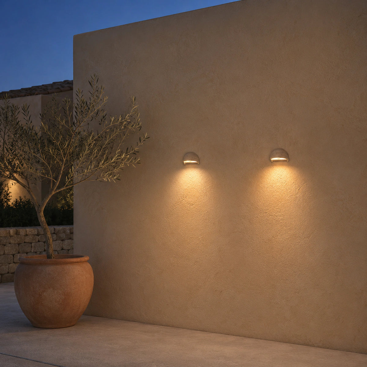 Culver travertine half dome wall light mounted beside an entrance door