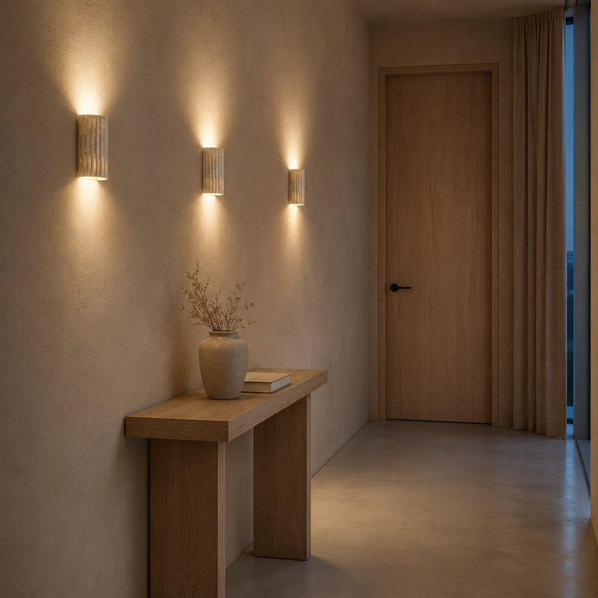 Ancaster fluted travertine wall light in a hallway of a period property