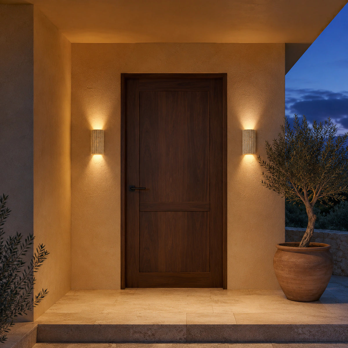 Ancaster fluted travertine wall light mounted beside an entrance door