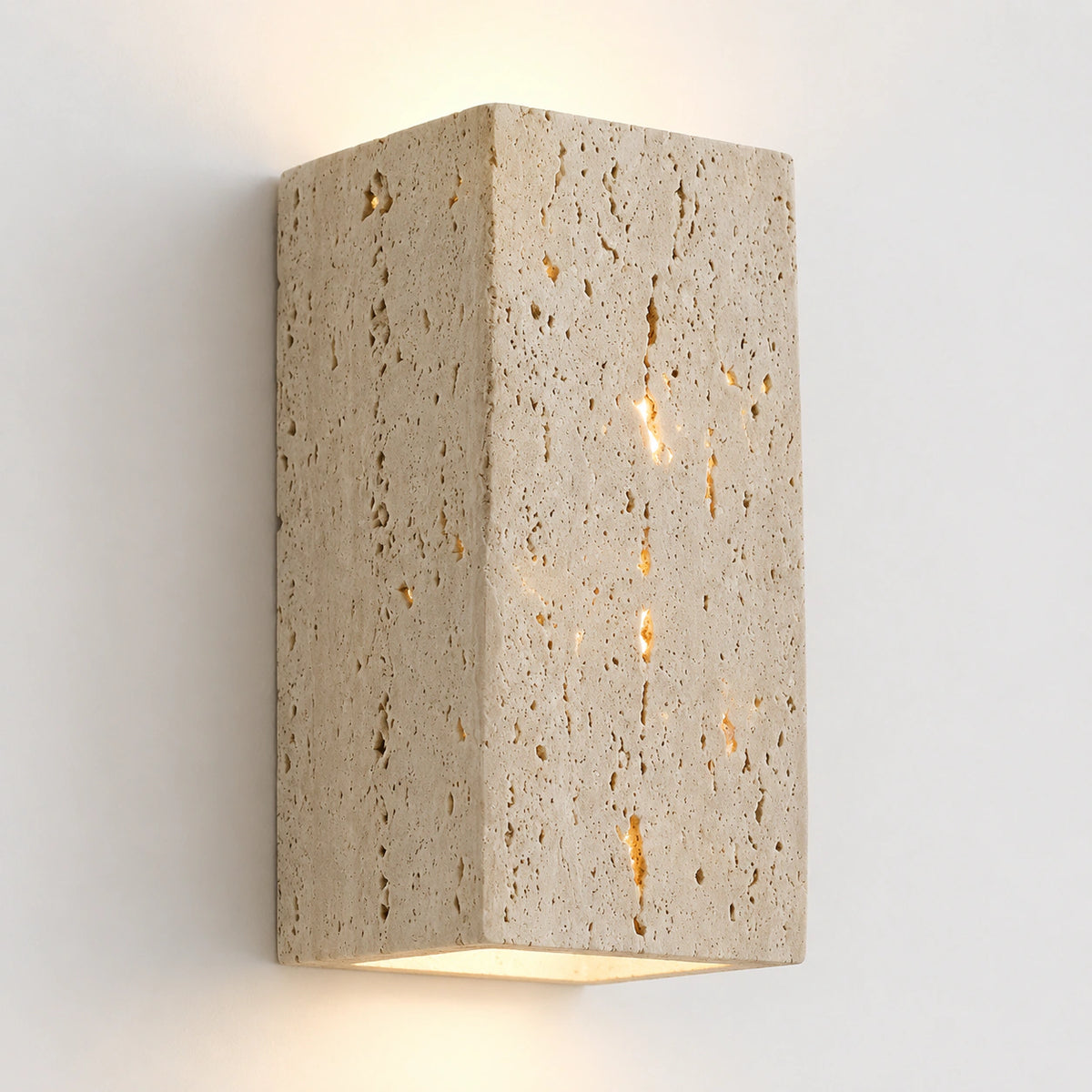 Slim cream travertine wall light with the stone face glowing from within
