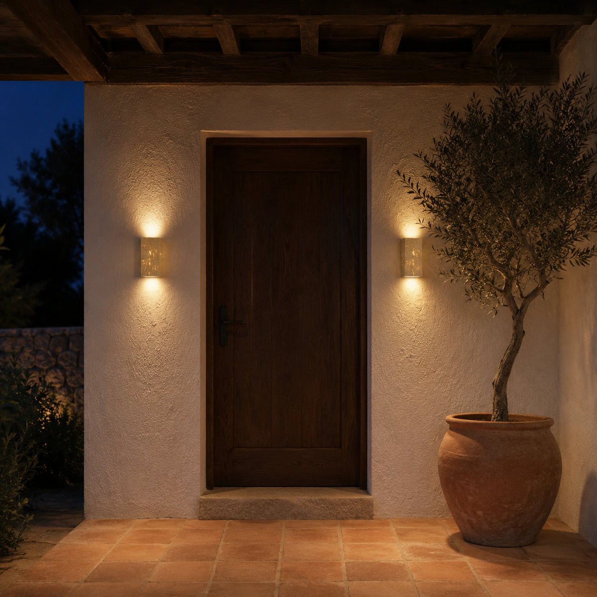 Newlyn slim travertine wall light mounted beside an entrance door
