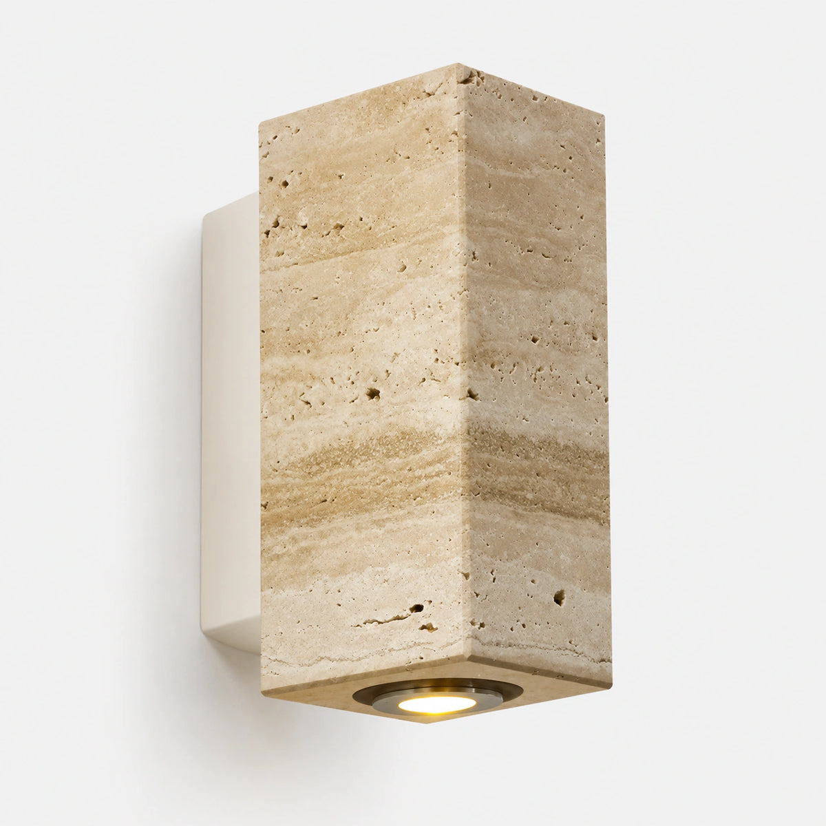 Honey travertine block wall light on a white backplate, lit from below
