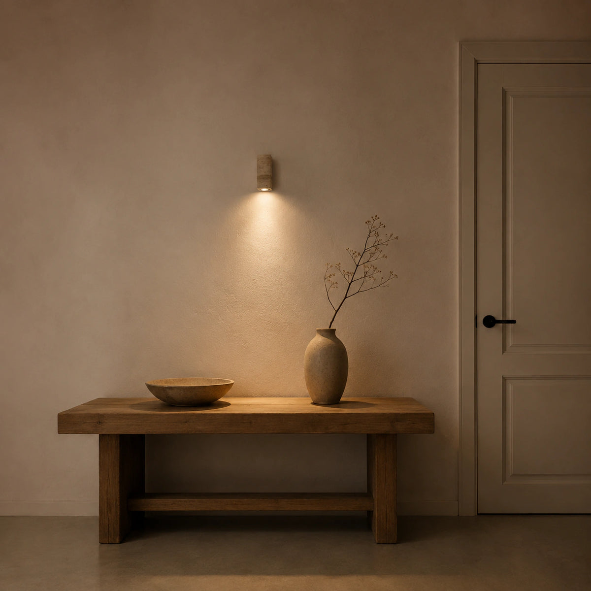 Ledbury travertine block wall light with a white backplate in a hallway