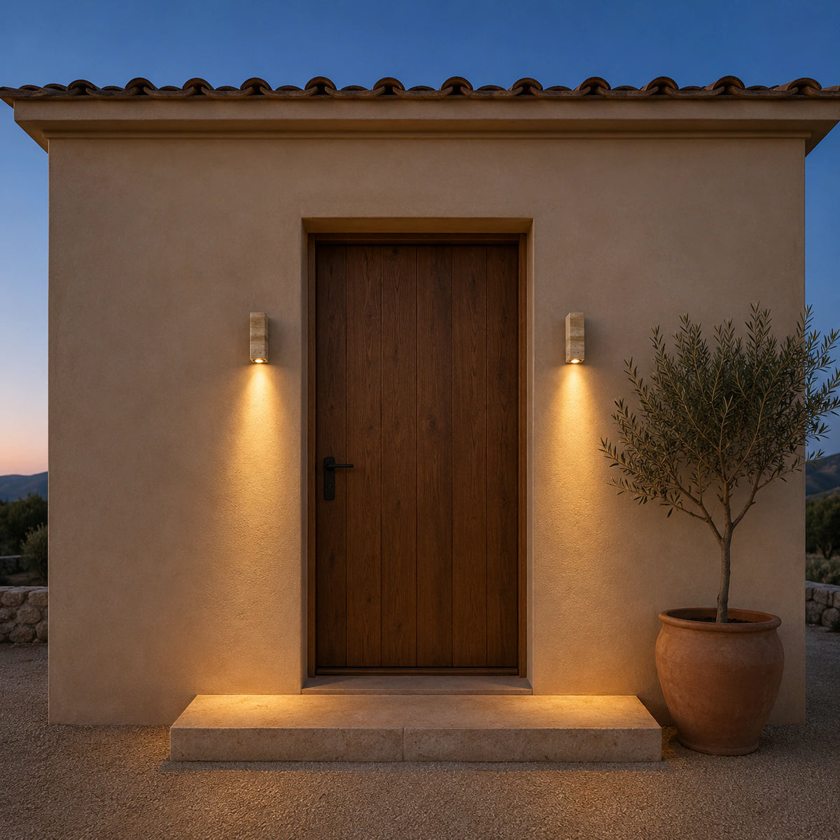 Ledbury travertine block wall light with a white backplate beside an entrance door