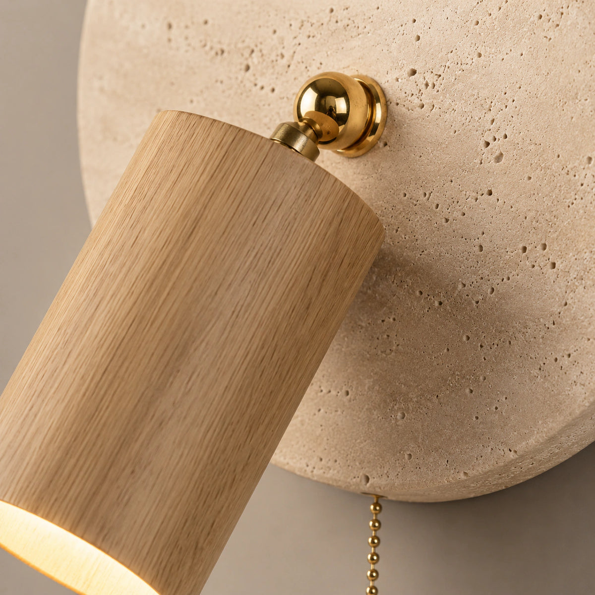 Close-up of the oak spot and ball joint on the Bramfield travertine wall light
