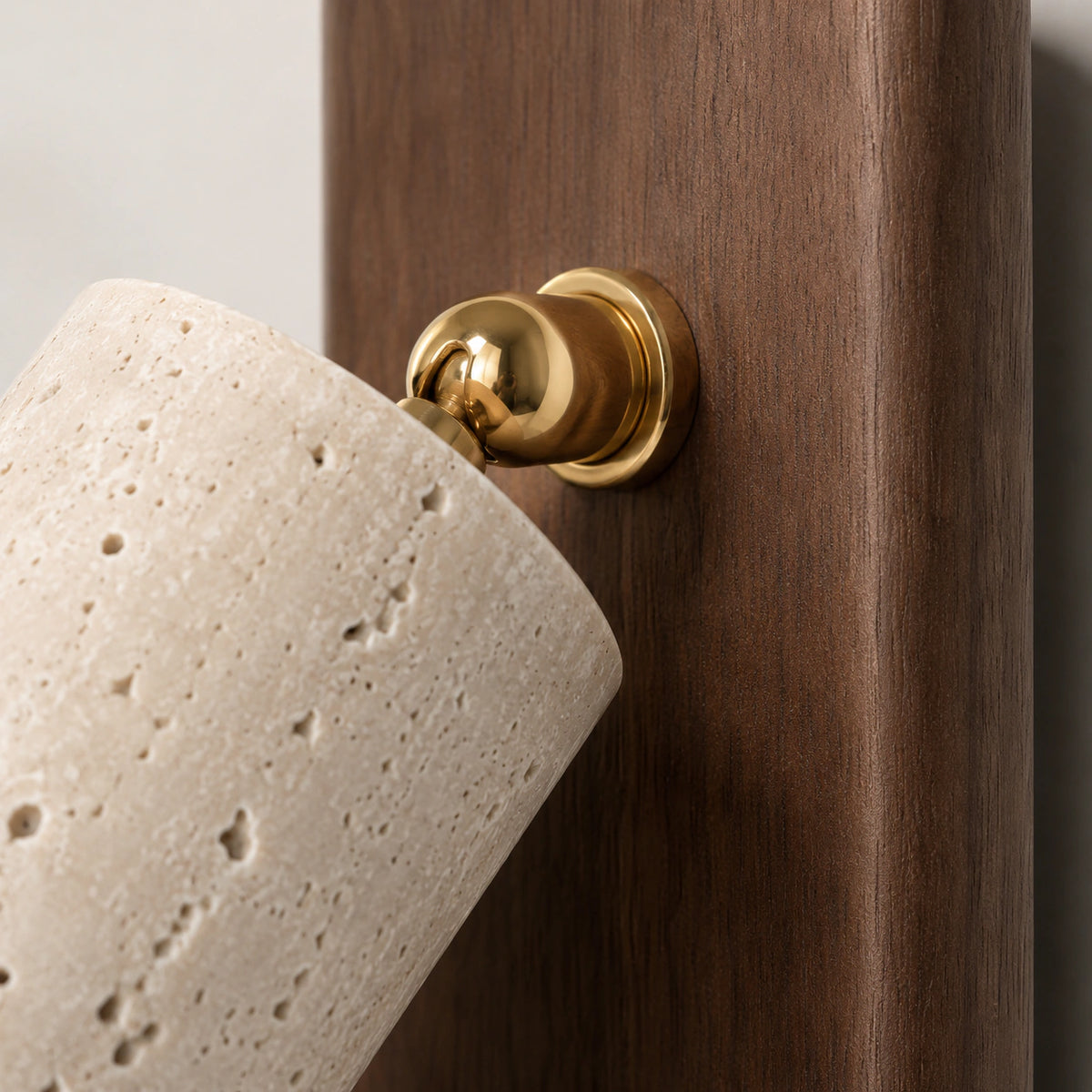 Close-up of the brass push button and travertine spot on the Thurlow reading light