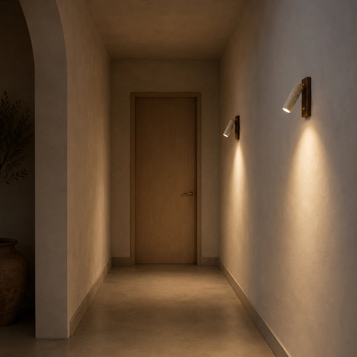 Thurlow travertine reading light aimed along a hallway wall