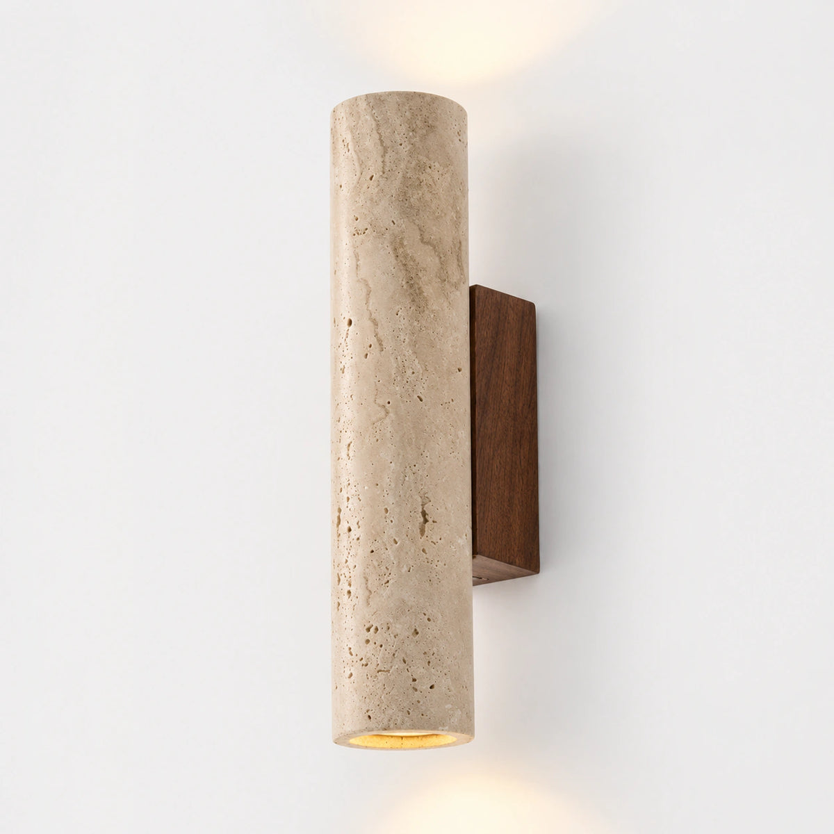Tall beige travertine tube wall light on a walnut backplate, lit at both ends